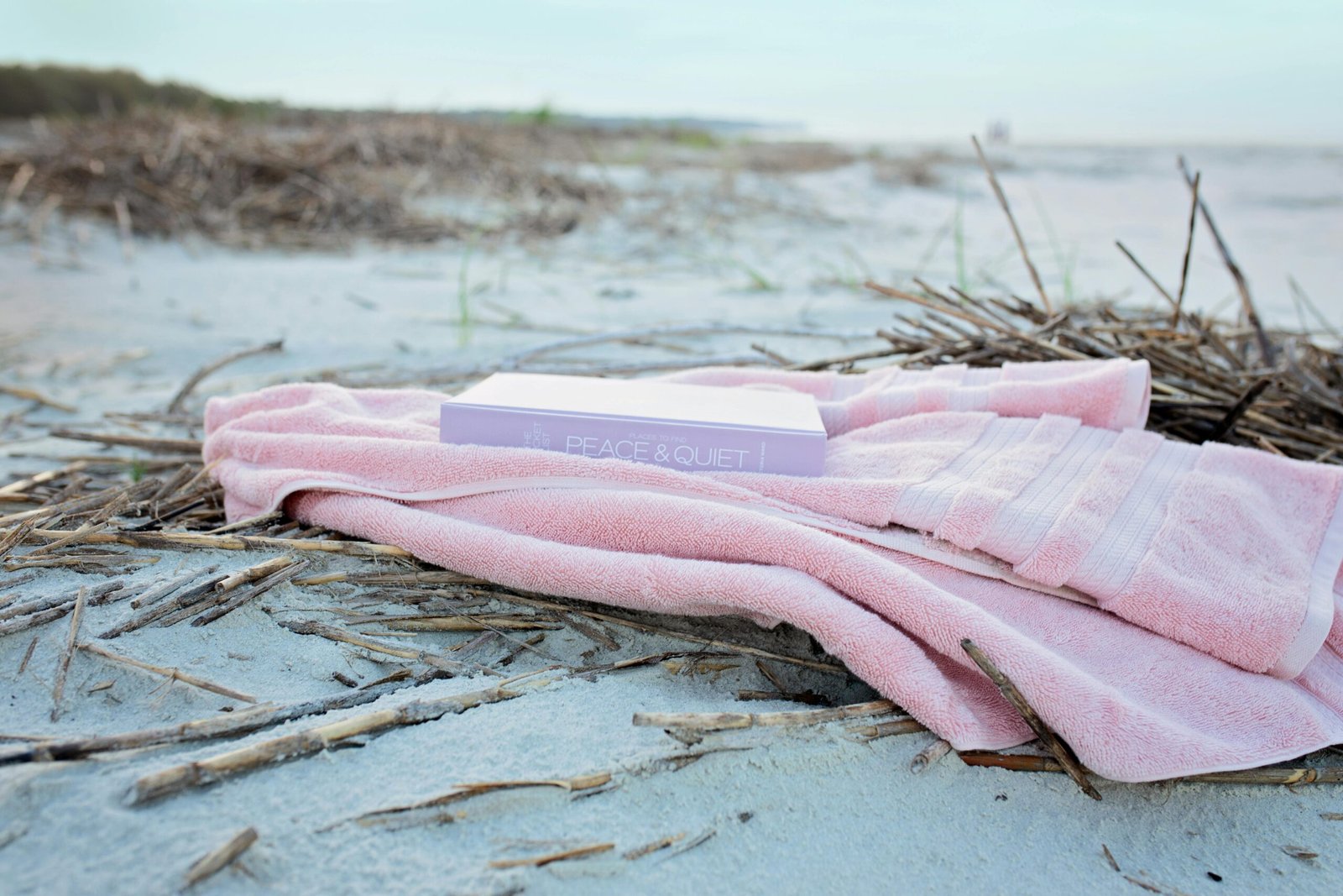Pink towel and book 'Peace & Quiet' on secluded beach, Hilton Head Island.